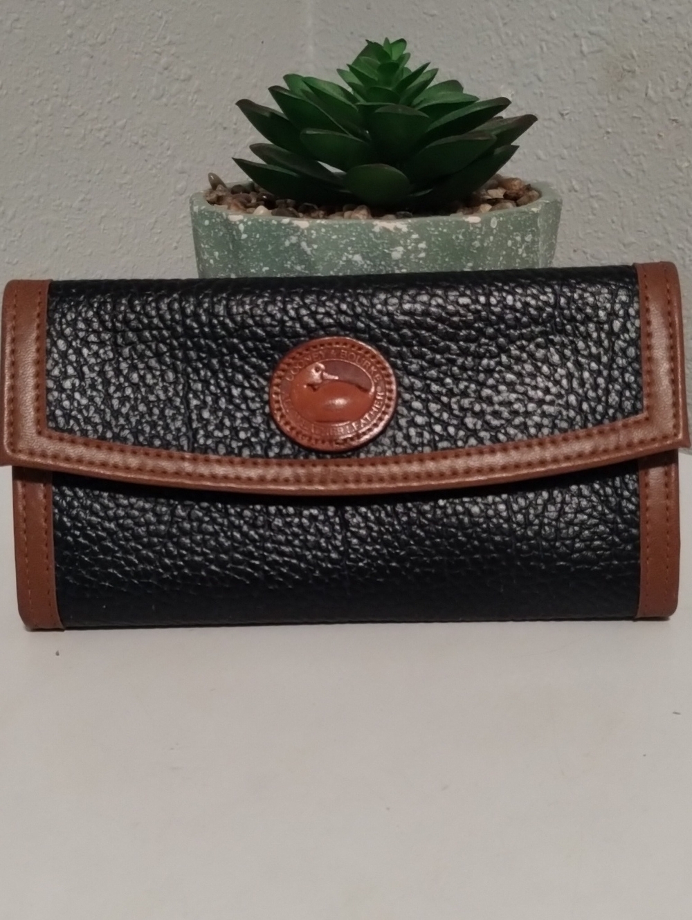 Dooney & Bourke Black Pebbled Leather Continental Wallet with Brown Trim
